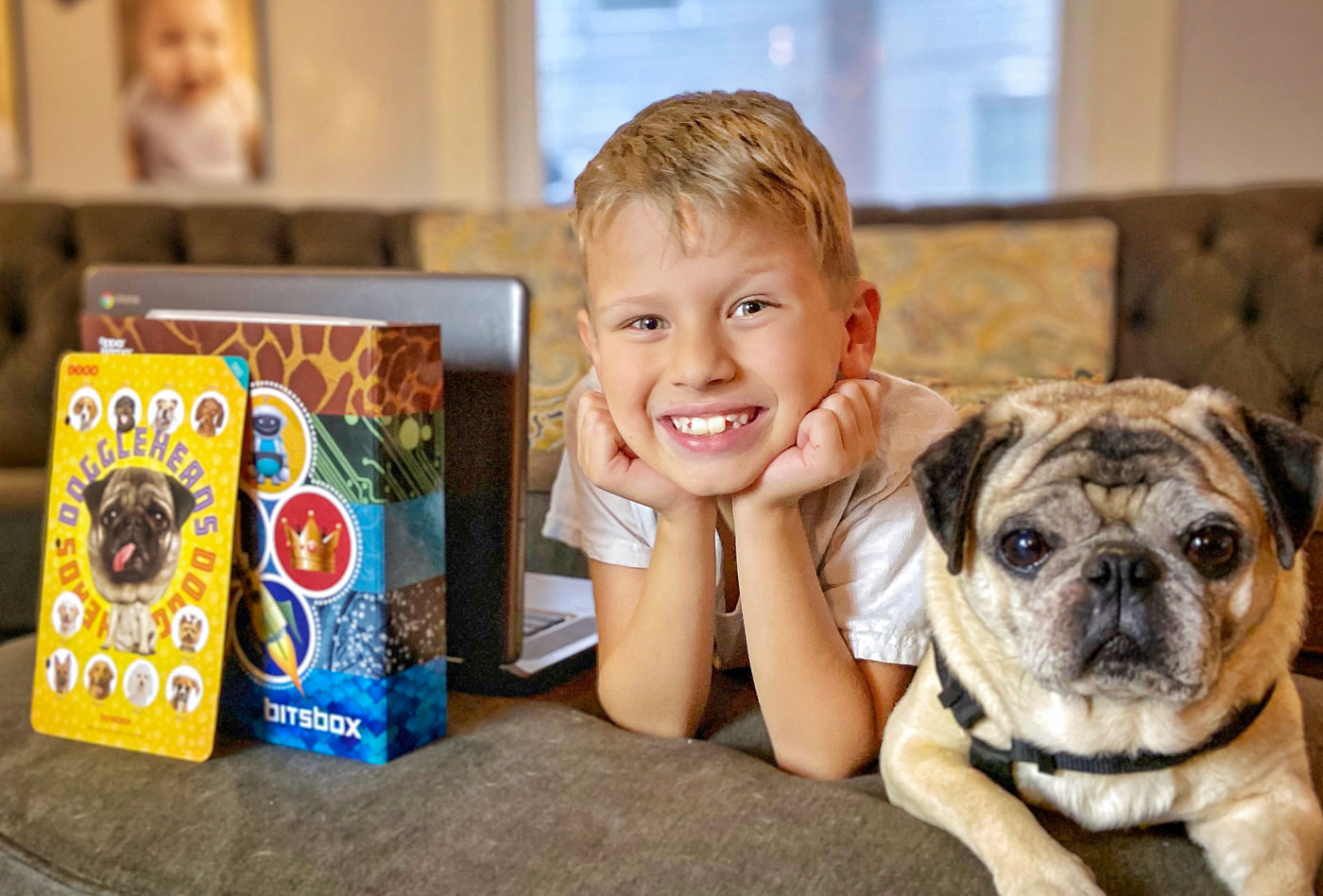 Cute kid coding with a pug